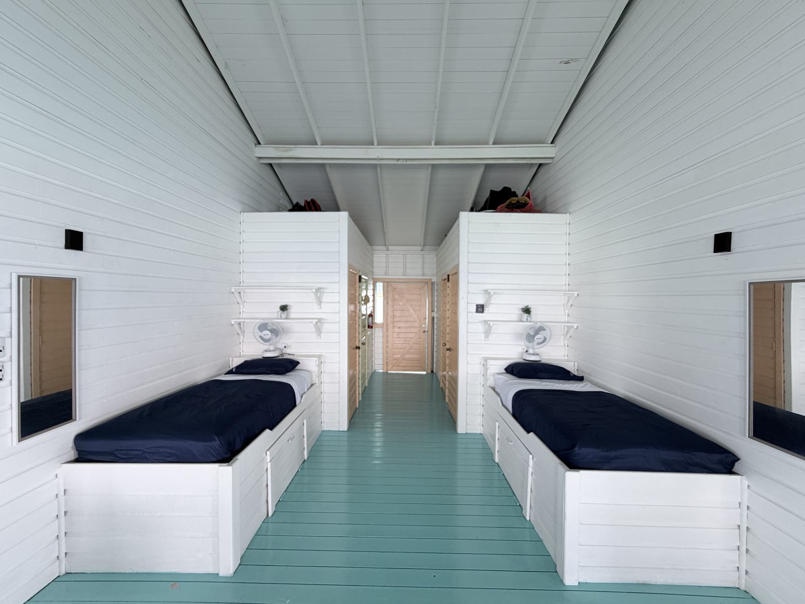 Bright white sleeping area at Casa Clearwater with two single beds