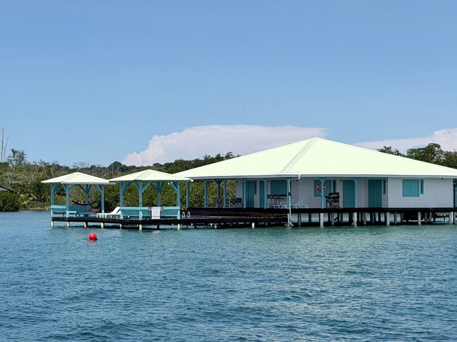 Casa Clearwater and its boathouse standing over turquoise water in daylight